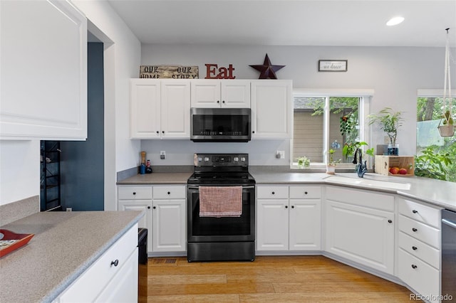 12277 W Chenango Dr, Morrison, CO 80465 - kitchen with stainless steel appliances, light countertops, white cabinets, and recessed lighting