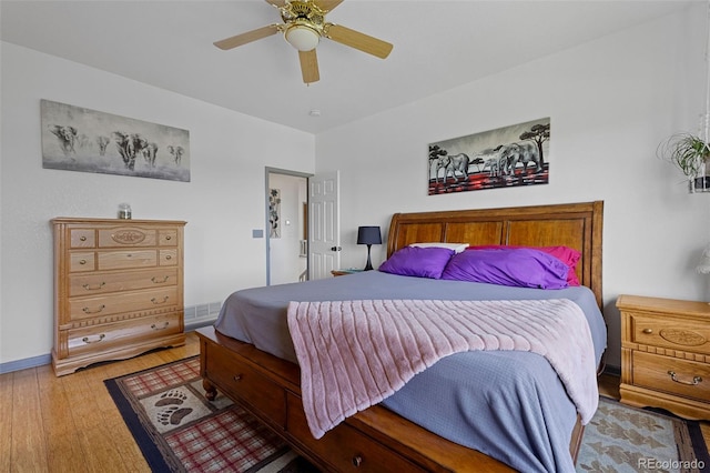 12277 W Chenango Dr, Morrison, CO 80465 - bedroom with wood finished floors and a ceiling fan