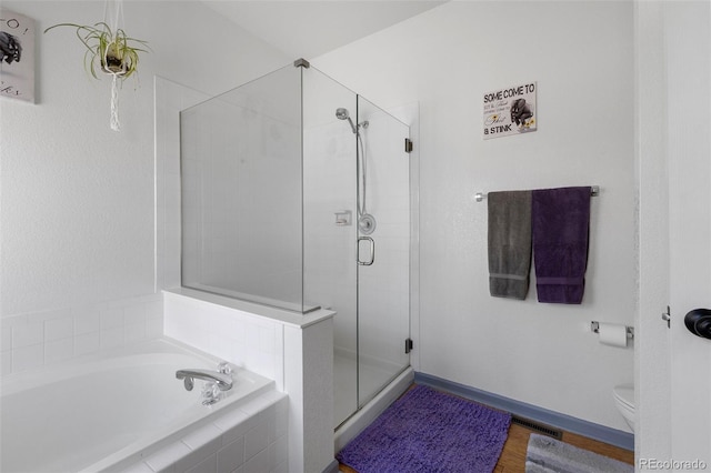 12277 W Chenango Dr, Morrison, CO 80465 - full bathroom with a garden tub, a stall shower, and wood finished floors