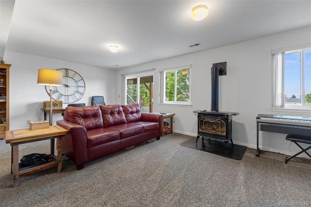 12277 W Chenango Dr, Morrison, CO 80465 - carpeted living room with a wood stove and baseboards