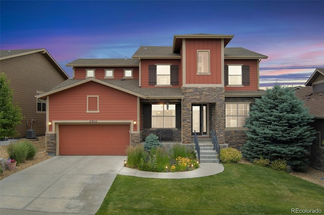 21962 E Idyllwilde Dr, Parker, CO 80138 - view of front facade featuring stone siding, driveway, a lawn, a garage, and board and batten siding