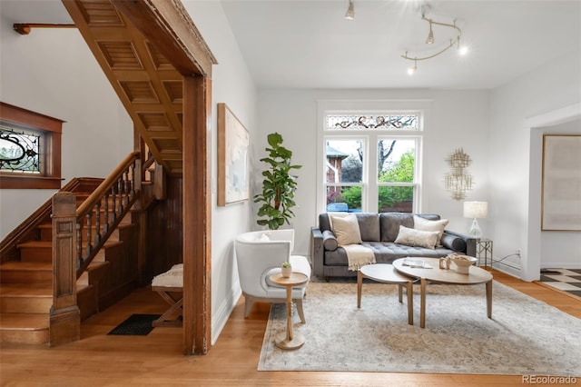 interior space with stairway, baseboards, and light wood-style floors