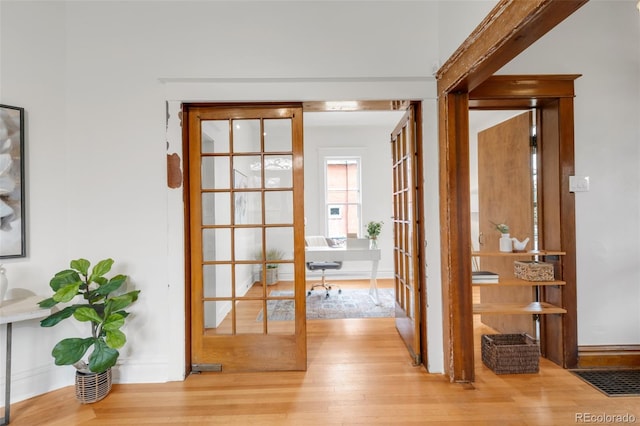 doorway to outside featuring french doors and wood finished floors
