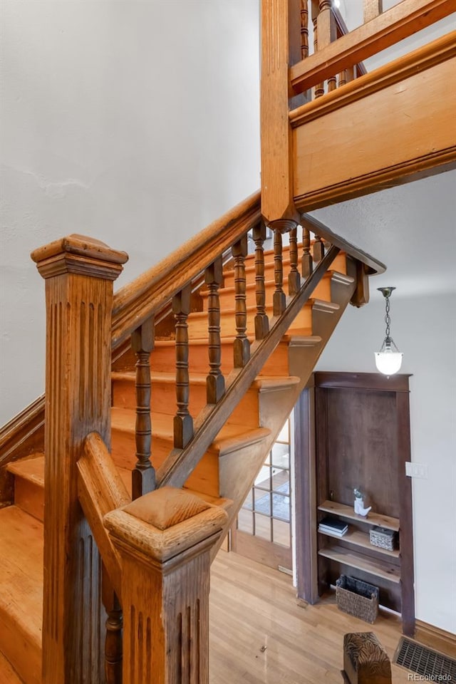 staircase featuring wood finished floors