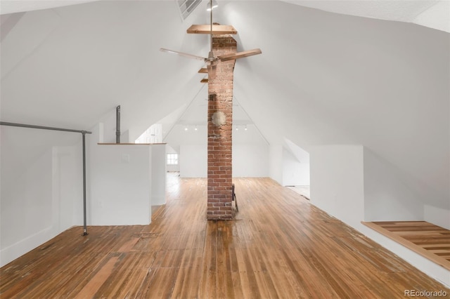 bonus room with wood finished floors, ornate columns, and lofted ceiling