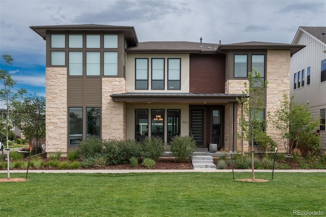 view of front of property with metal roof, stone siding, a front lawn, and a standing seam roof