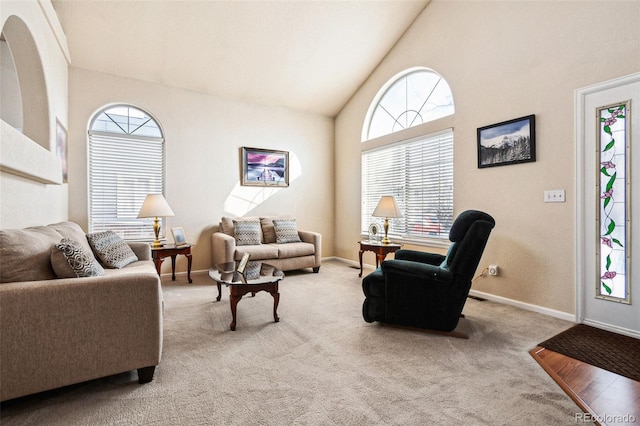 living room featuring light carpet and high vaulted ceiling