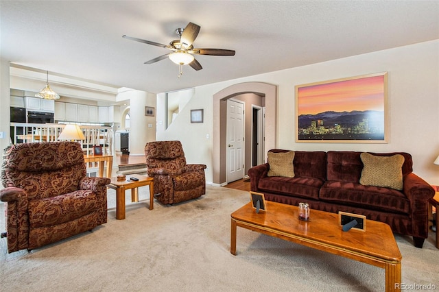 living room featuring light carpet and ceiling fan