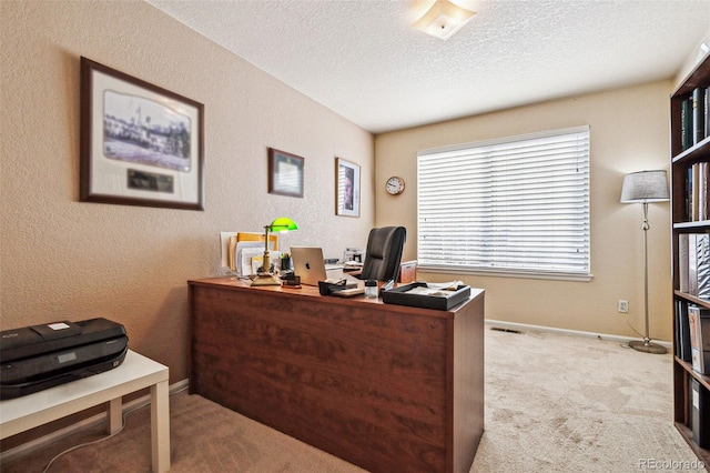 office with light carpet and a textured ceiling