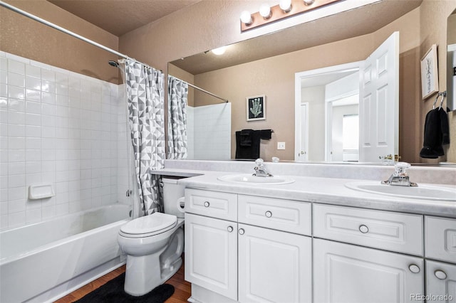 full bathroom featuring hardwood / wood-style flooring, vanity, shower / tub combo with curtain, and toilet