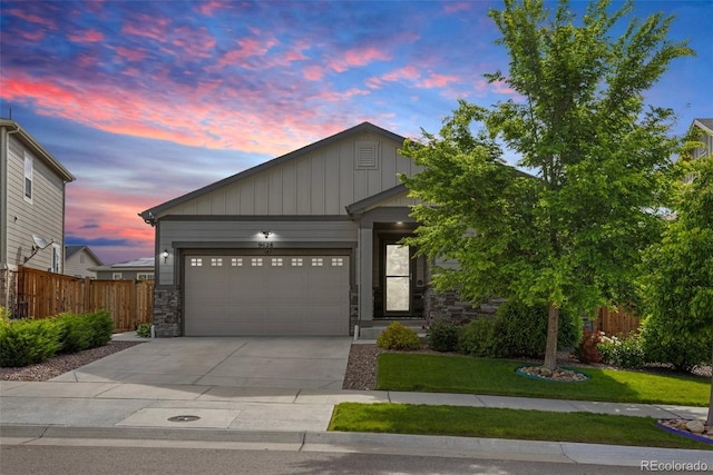 9628 Albion Ln, Thornton, CO 80229 - view of front of property featuring driveway, a garage, and stone siding