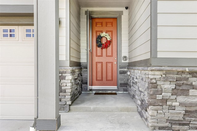 9628 Albion Ln, Thornton, CO 80229 - view of exterior entry featuring a security system and stone siding