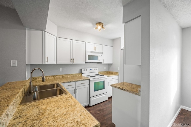 kitchen with dark wood-type flooring, sink, white cabinetry, a textured ceiling, and white appliances