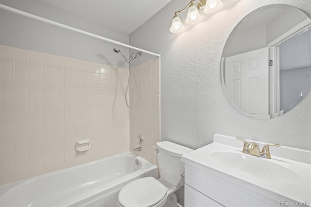 full bathroom with vanity, toilet, and tiled shower / bath combo