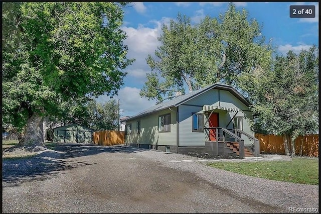 view of front of property with a storage shed