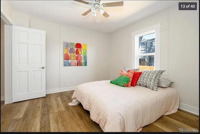 bedroom with ceiling fan and wood-type flooring