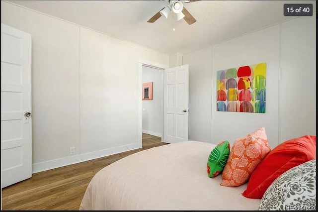 bedroom with dark hardwood / wood-style flooring and ceiling fan