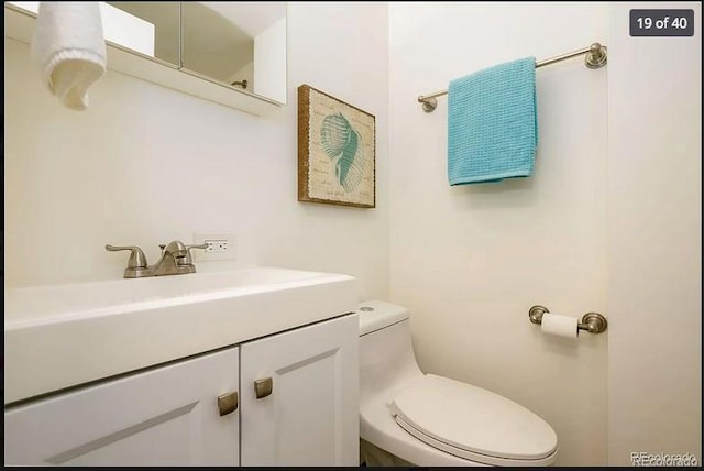 bathroom featuring vanity and toilet