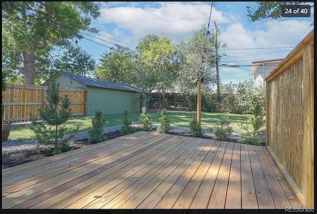 wooden terrace featuring a yard