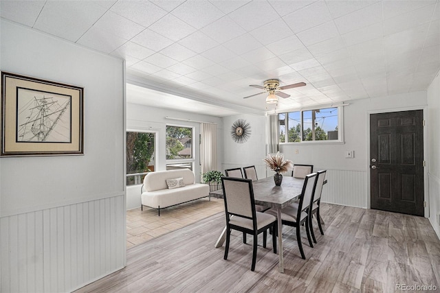 4051 S Cherokee St, Englewood, CO 80110 - dining space with plenty of natural light, light wood-style floors, wainscoting, and a ceiling fan