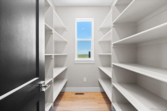 walk in closet featuring light hardwood / wood-style floors