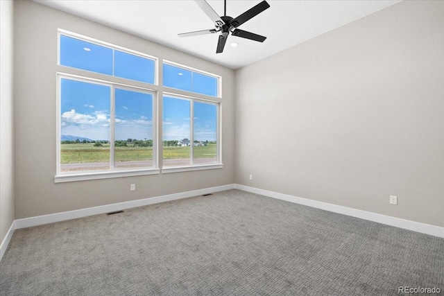 carpeted empty room featuring ceiling fan