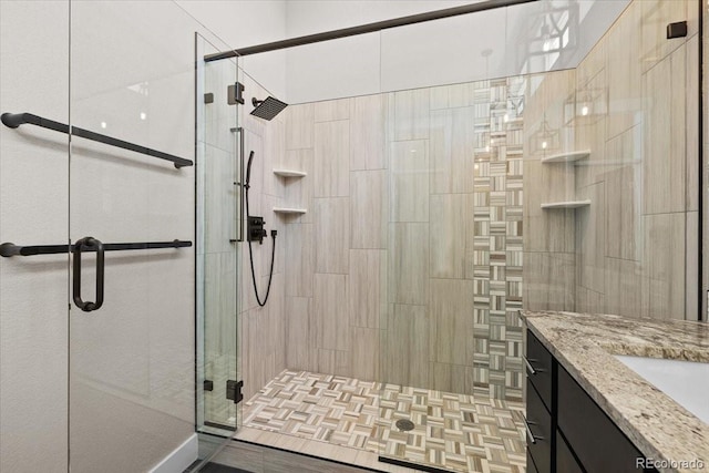 bathroom featuring walk in shower and vanity