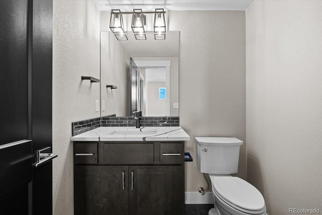 bathroom with toilet and vanity