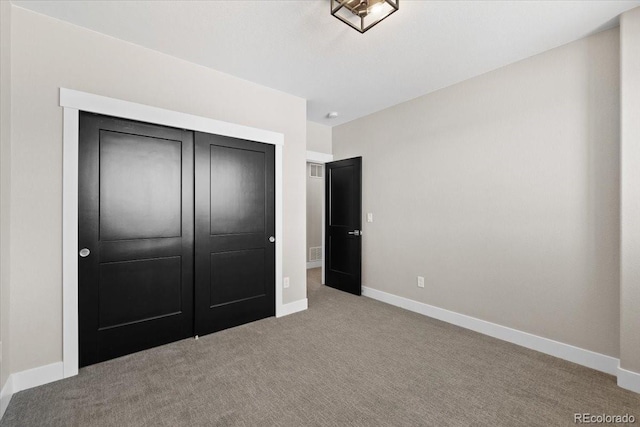 unfurnished bedroom with a closet and light carpet