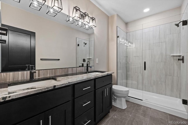 bathroom with tile patterned flooring, toilet, vanity, and a shower with shower door