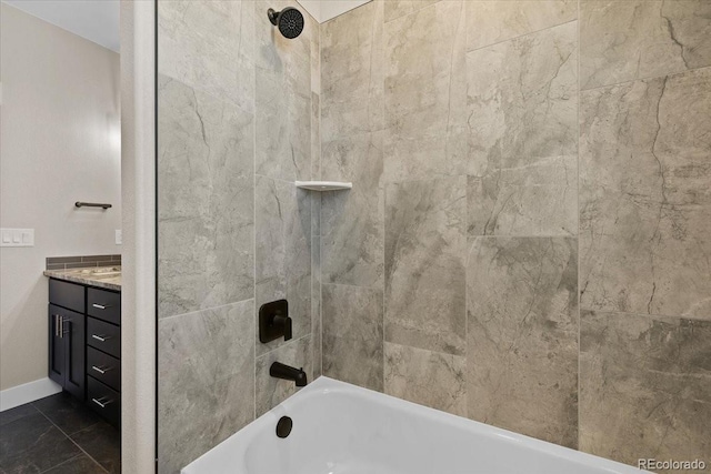 bathroom featuring vanity, tiled shower / bath, and tile patterned floors