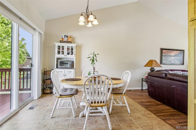 16304 10th St, Mead, CO 80542 - dining area featuring vaulted ceiling, a chandelier, and baseboards