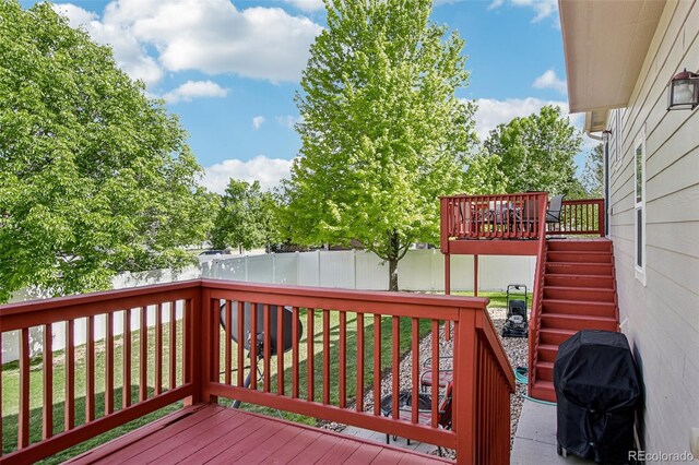 16304 10th St, Mead, CO 80542 - wooden deck with a fenced backyard, area for grilling, and stairs