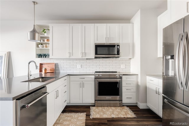 kitchen featuring appliances with stainless steel finishes, sink, white cabinets, and decorative backsplash