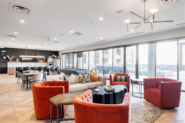 living room with light parquet floors, a wealth of natural light, and an inviting chandelier