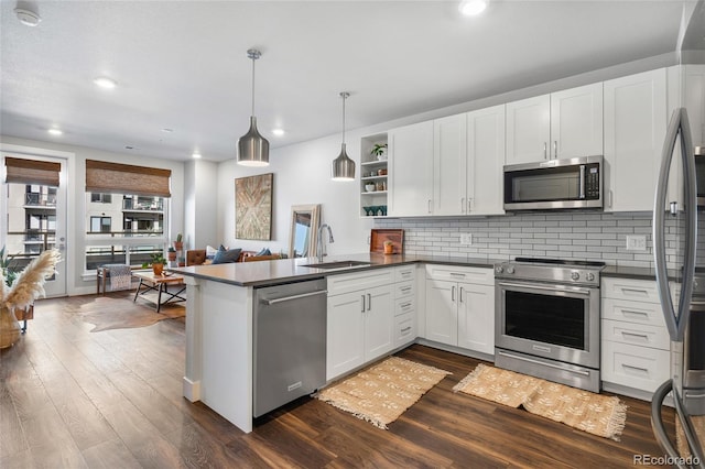 kitchen with white cabinetry, pendant lighting, kitchen peninsula, and appliances with stainless steel finishes