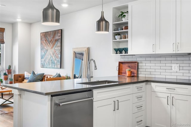 kitchen with pendant lighting, dishwasher, sink, and white cabinets