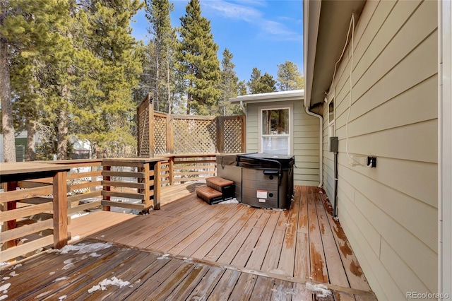 wooden terrace featuring area for grilling and a hot tub