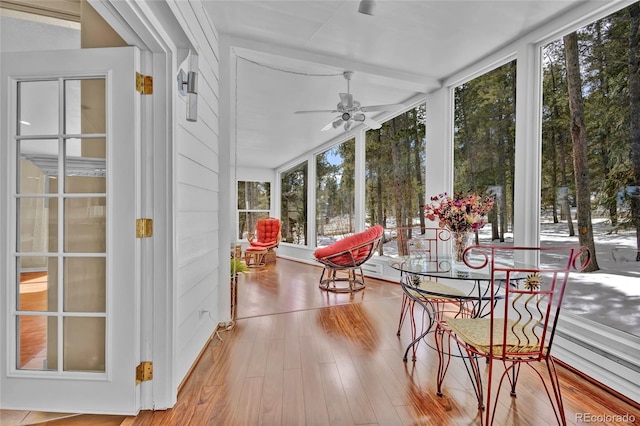 sunroom featuring a ceiling fan