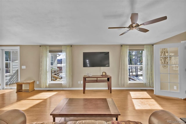 living area featuring ceiling fan, wood finished floors, and baseboards