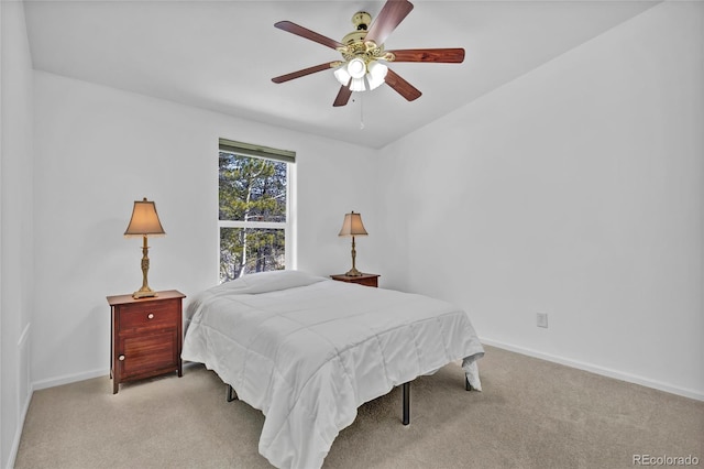 bedroom featuring baseboards, ceiling fan, and light colored carpet