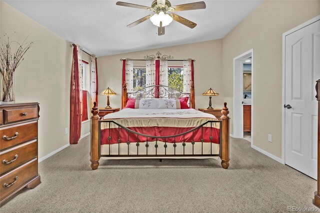 bedroom with vaulted ceiling, carpet, and baseboards