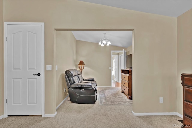 sitting room with carpet floors, baseboards, a chandelier, and lofted ceiling