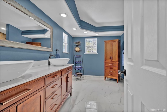 full bathroom with recessed lighting, a sink, baseboards, marble finish floor, and double vanity