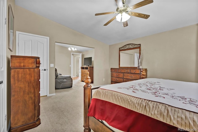 carpeted bedroom featuring vaulted ceiling, baseboards, and ceiling fan with notable chandelier