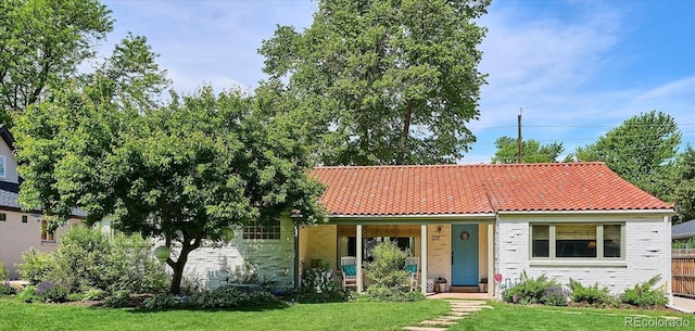 225 N Ivanhoe St, Denver, CO 80220 - view of front of property with a front yard, brick siding, a tile roof, and covered porch