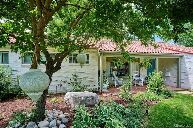 225 N Ivanhoe St, Denver, CO 80220 - view of front of house with a tile roof and brick siding