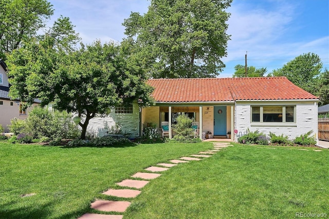 225 N Ivanhoe St, Denver, CO 80220 - ranch-style home with a front yard, a porch, a tiled roof, and brick siding