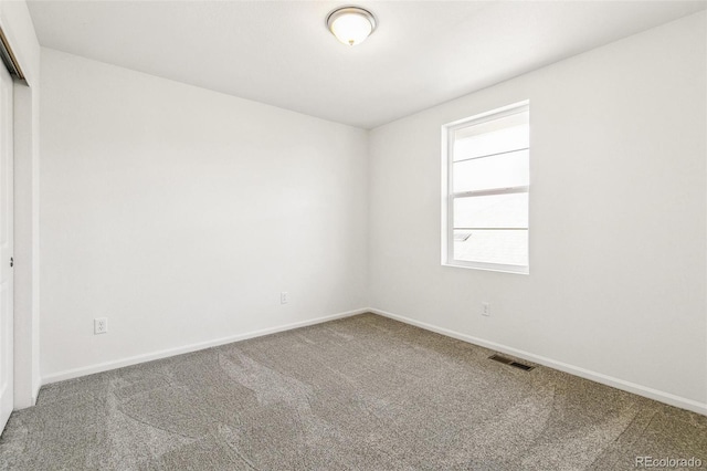 carpeted empty room with baseboards and visible vents