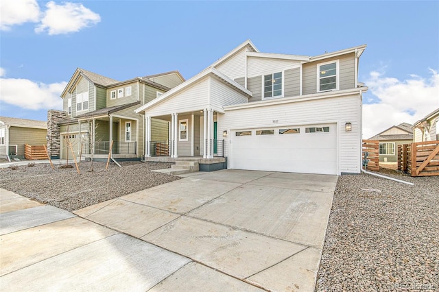 view of front of property featuring covered porch, driveway, an attached garage, and fence